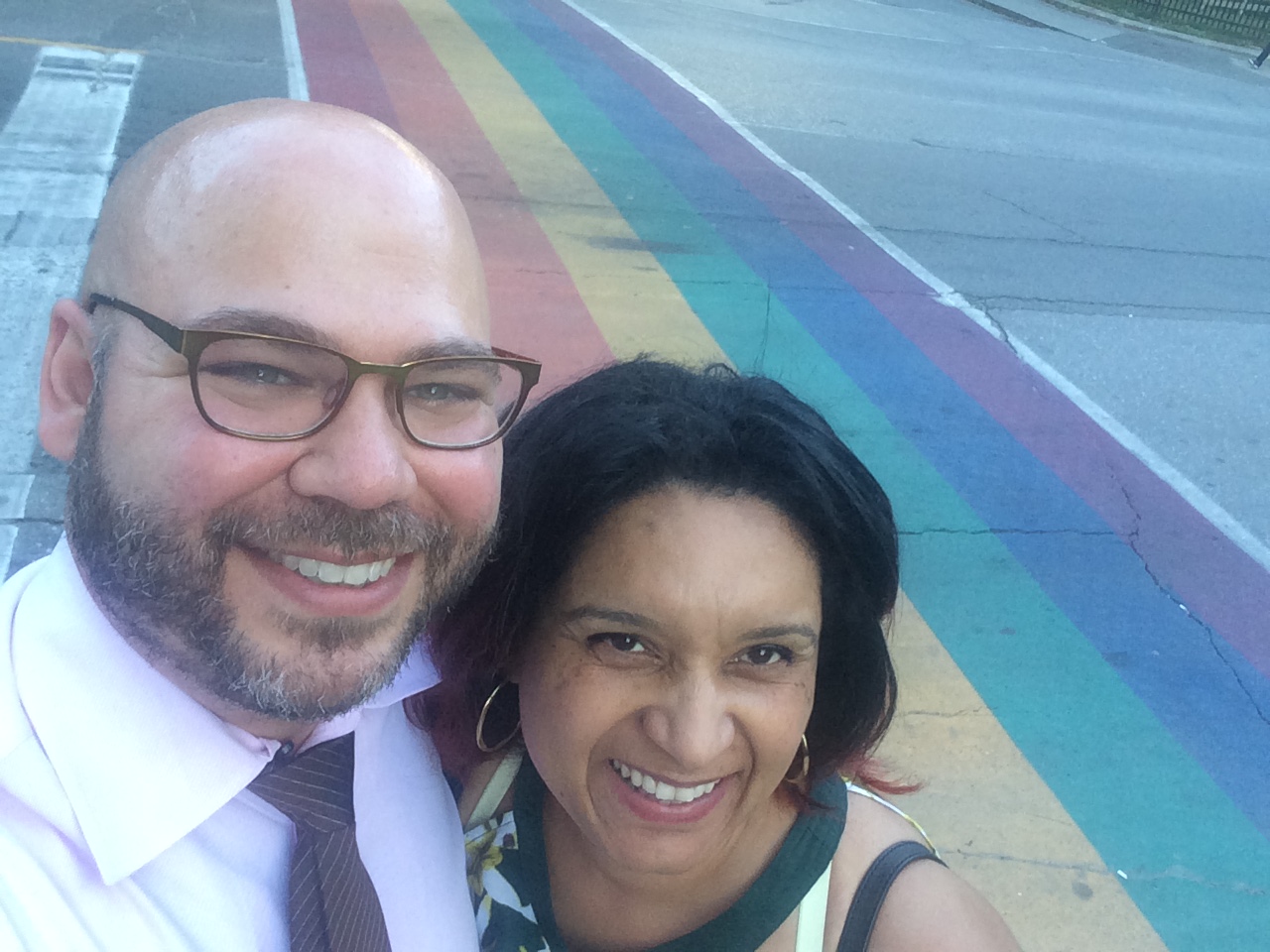 Dr. Matthew Skinta and Dr. Monnica Williams in Toronto in front of a rainbow street crossing.